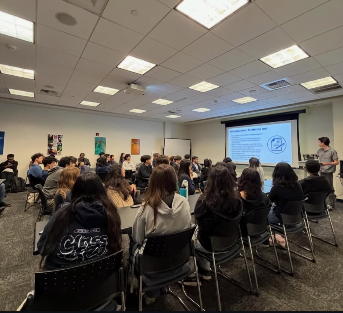 A guest speaker guiding students through a research program